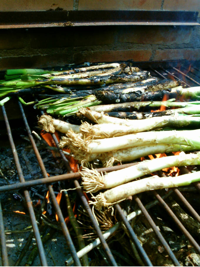 The Spanish tradition of roasted calçots is possible to do at home even if you don't have calçots. Leeks make a great substitute and the romesco sauce is to die for.